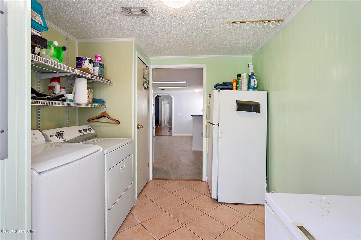 2987 Green Acres Road St. Augustine, FL 32084 - Photo 21 of 31 a utility room with cabinets washer and dryer