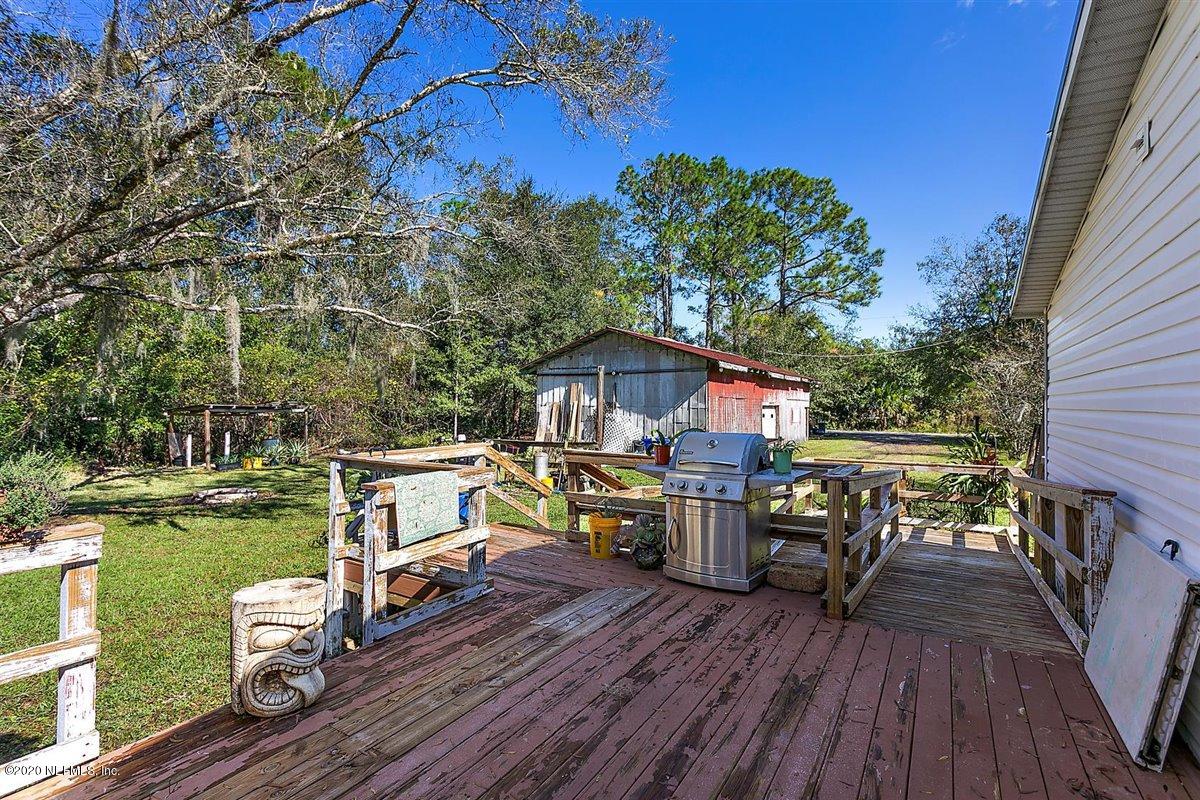 2987 Green Acres Road St. Augustine, FL 32084 - Photo 22 of 31 a view of house with deck and outdoor seating