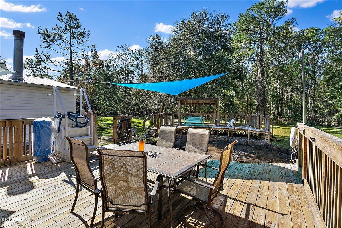 2987 Green Acres Road St. Augustine, FL 32084 - Photo 23 of 31 a view of a backyard with sitting area