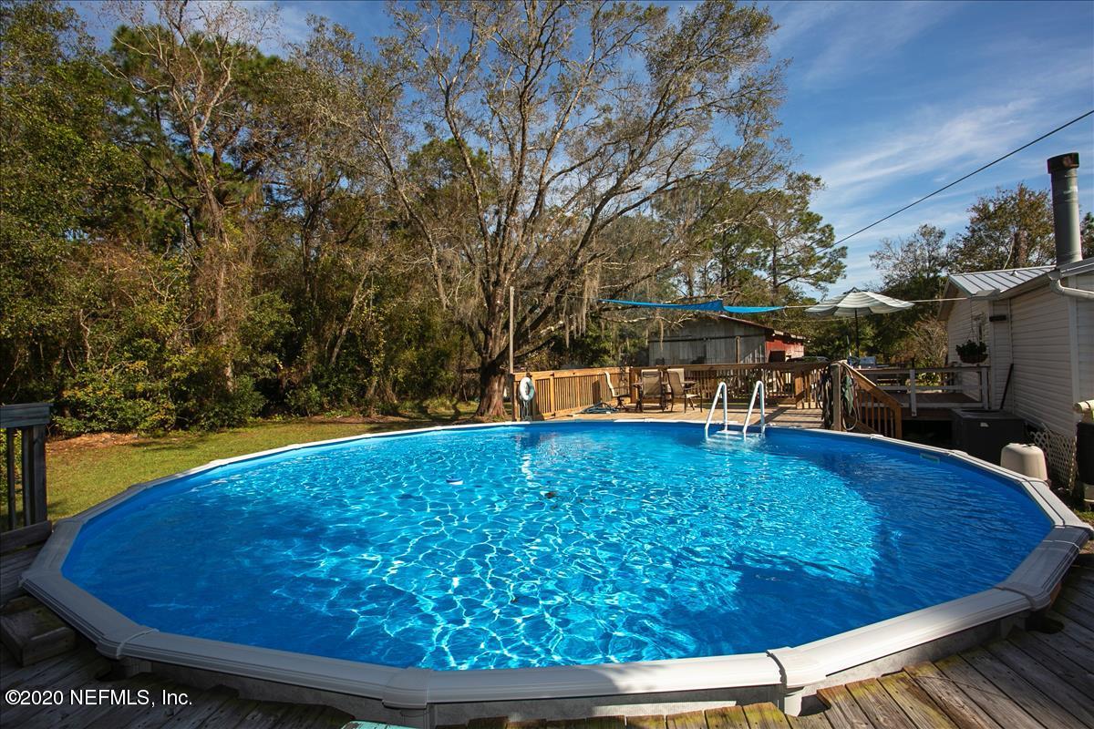 2987 Green Acres Road St. Augustine, FL 32084 - Photo 24 of 31 a view of a swimming pool with an outdoor seating