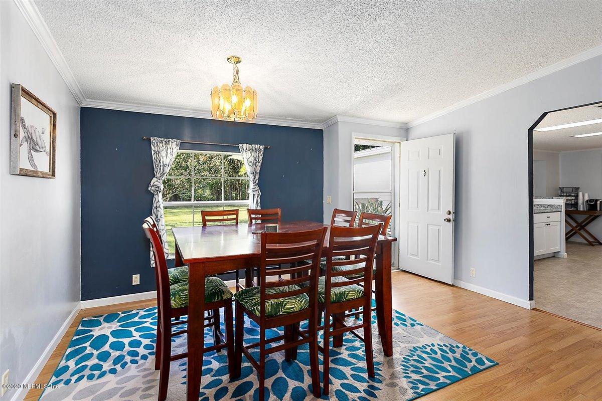 2987 Green Acres Road St. Augustine, FL 32084 - Photo 7 of 31 a view of a dining room with furniture window and wooden floor