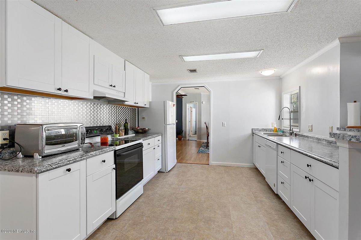2987 Green Acres Road St. Augustine, FL 32084 - Photo 9 of 31 a large kitchen with cabinets stainless steel appliances and a sink