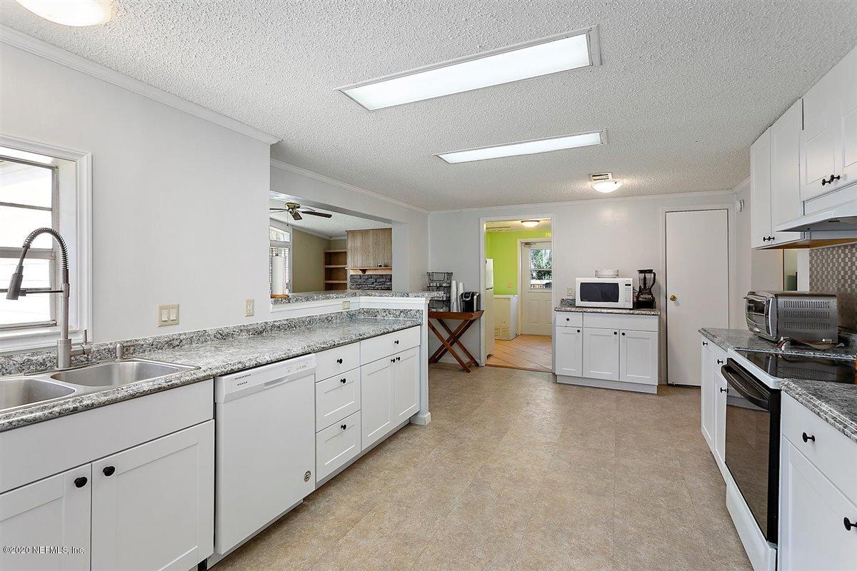 2987 Green Acres Road St. Augustine, FL 32084 - Photo 10 of 31 a large kitchen with kitchen island a sink stainless steel appliances and cabinets