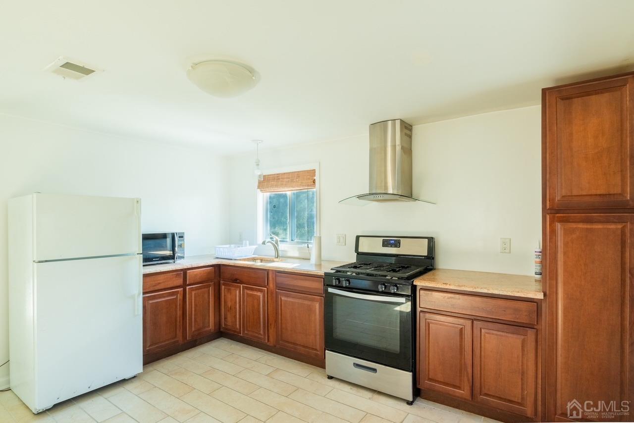 95 Tunison Road New Brunswick, NJ 08901 - Photo 11 of 29 a kitchen with a sink a stove and refrigerator