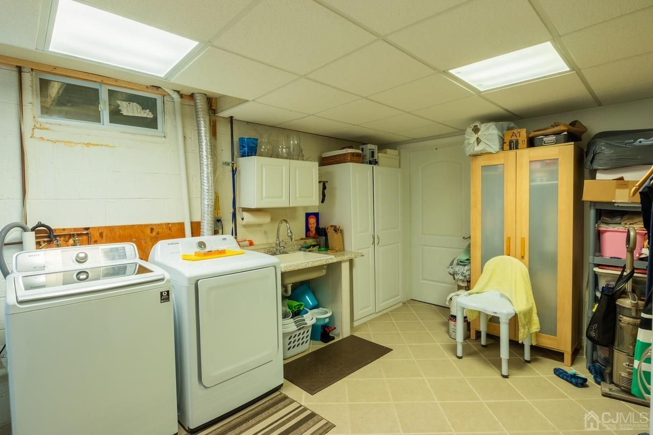 95 Tunison Road New Brunswick, NJ 08901 - Photo 22 of 29 a utility room with a sink and a washer dryer