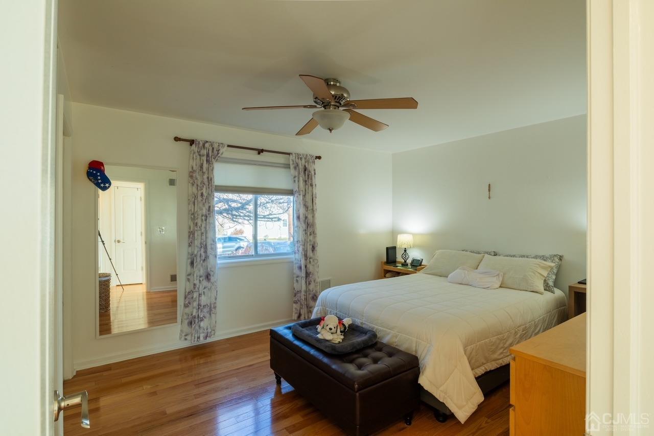 95 Tunison Road New Brunswick, NJ 08901 - Photo 8 of 29 a bedroom with a bed and wooden floor