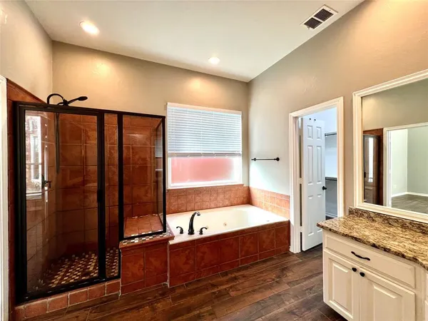 a large spacious bathroom with a large mirror and shower