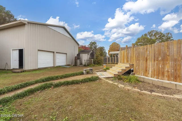 a backyard of a house with table and chairs