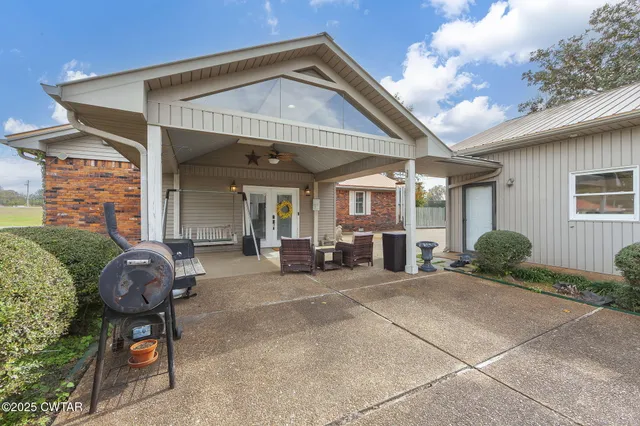 a front view of a house with patio furniture and a porch