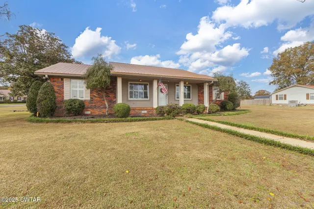 a front view of a house with a garden