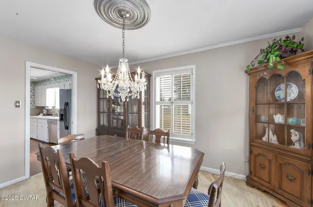 a view of a dining room with furniture wooden floor and chandelier