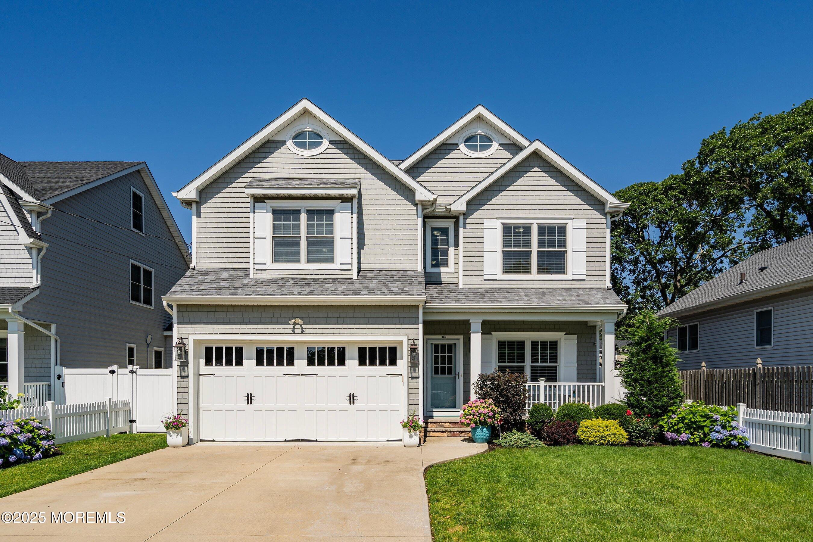 a front view of a house with a yard and trees