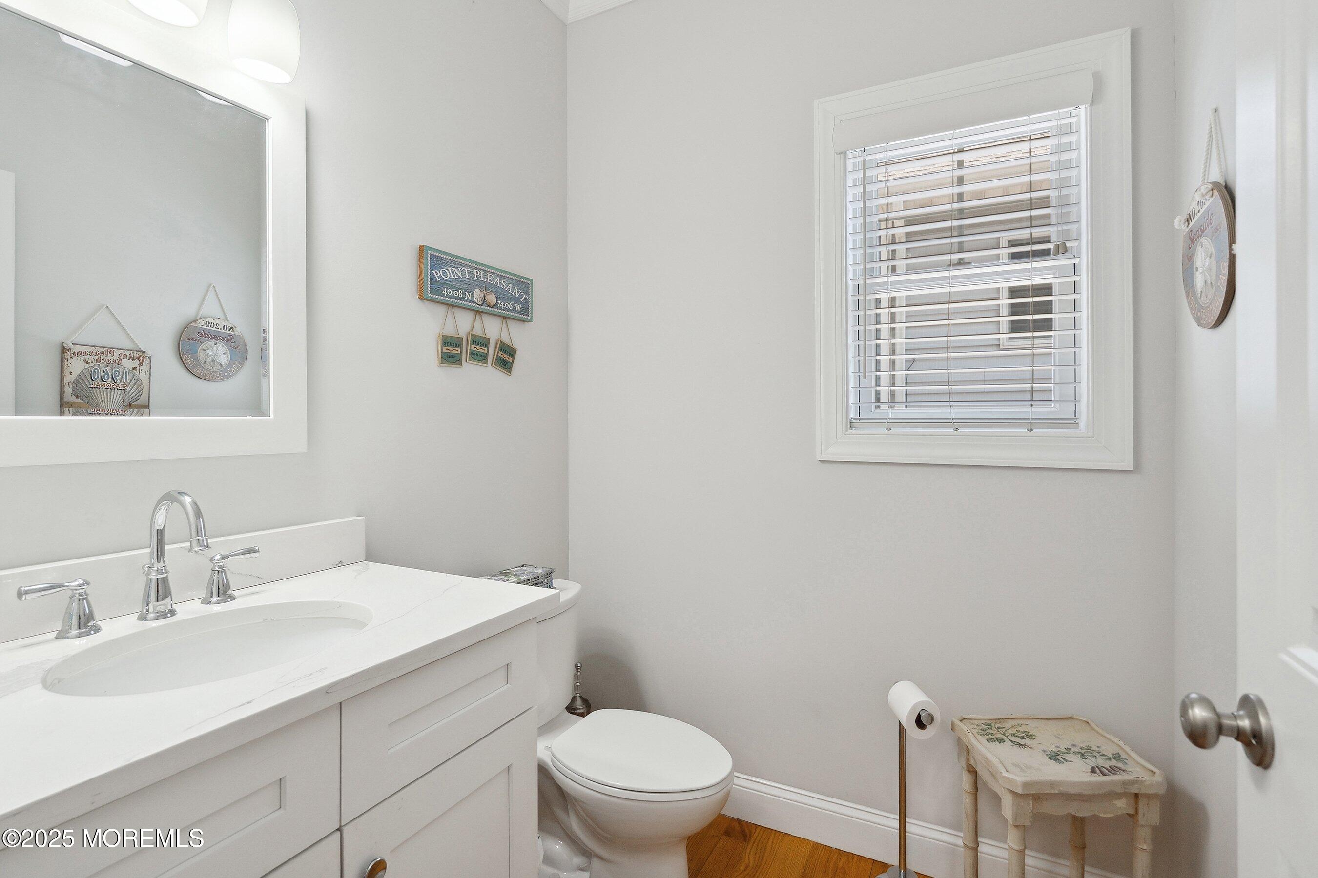 309 Hall Avenue Point Pleasant, NJ 08742 - Photo 13 of 35 a bathroom with a toilet a sink a mirror and a window