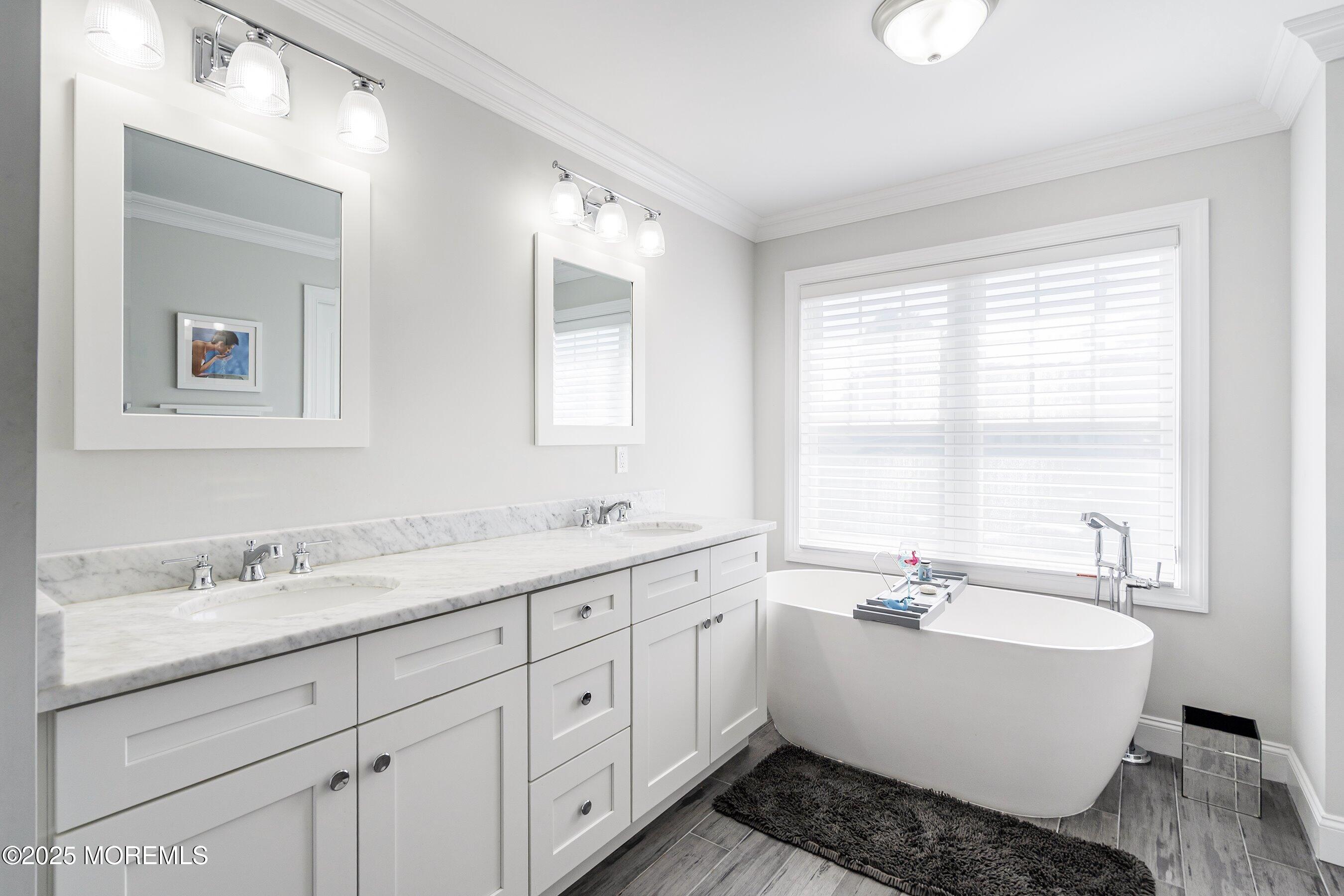 309 Hall Avenue Point Pleasant, NJ 08742 - Photo 15 of 35 a bathroom with a double vanity sink a mirror and a bathtub