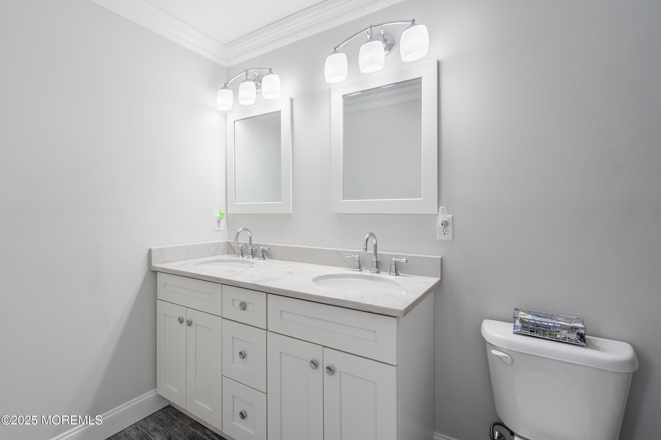 309 Hall Avenue Point Pleasant, NJ 08742 - Photo 22 of 35 a bathroom with a toilet sink and mirror