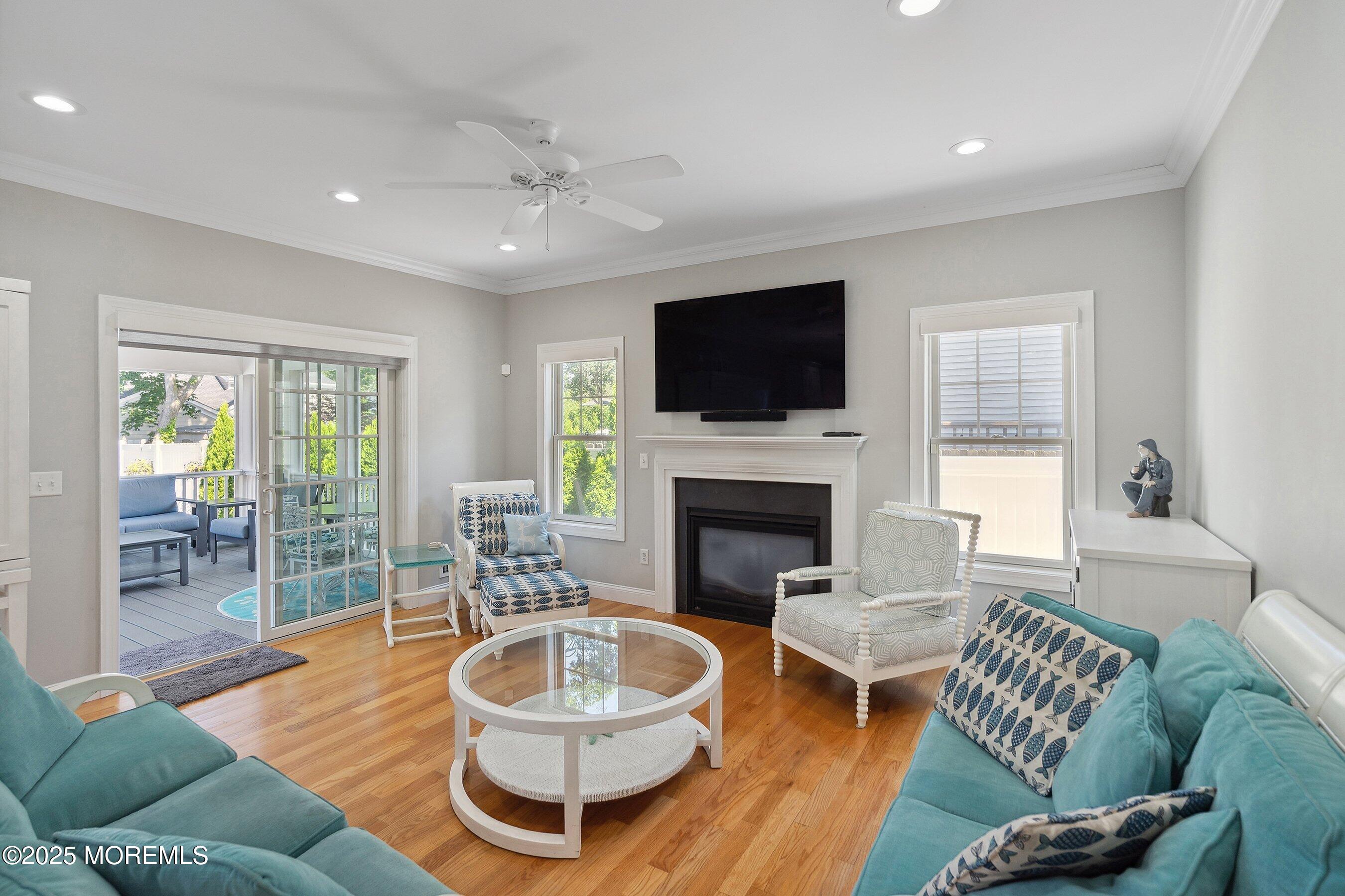 309 Hall Avenue Point Pleasant, NJ 08742 - Photo 10 of 35 a living room with furniture a fireplace and a flat screen tv