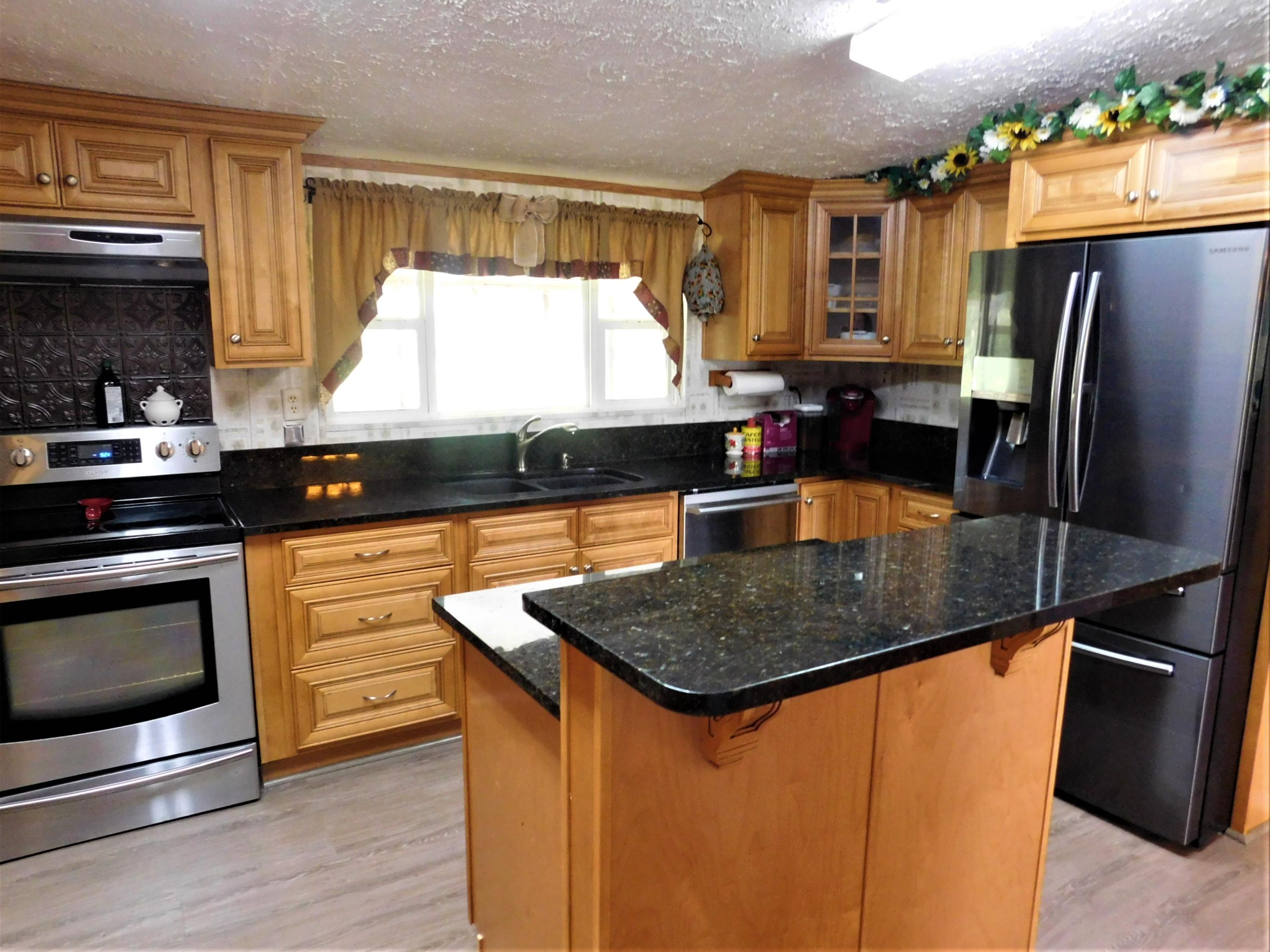 1533 Messick Road Baker, FL 32531 - Photo 2 of 40 a kitchen with stainless steel appliances granite countertop a sink a stove and a refrigerator