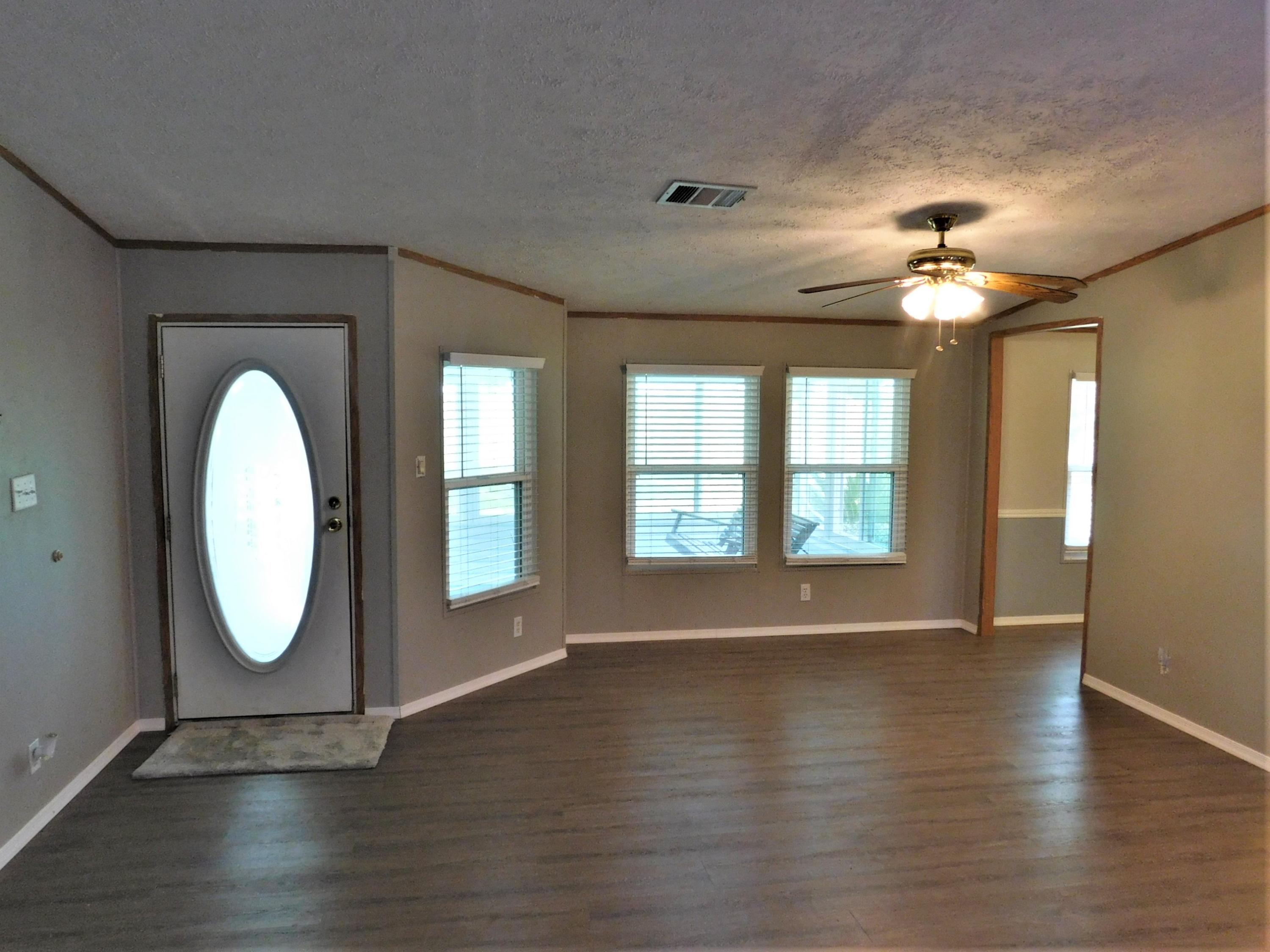1533 Messick Road Baker, FL 32531 - Photo 18 of 40 a view of an empty room with wooden floor and a window