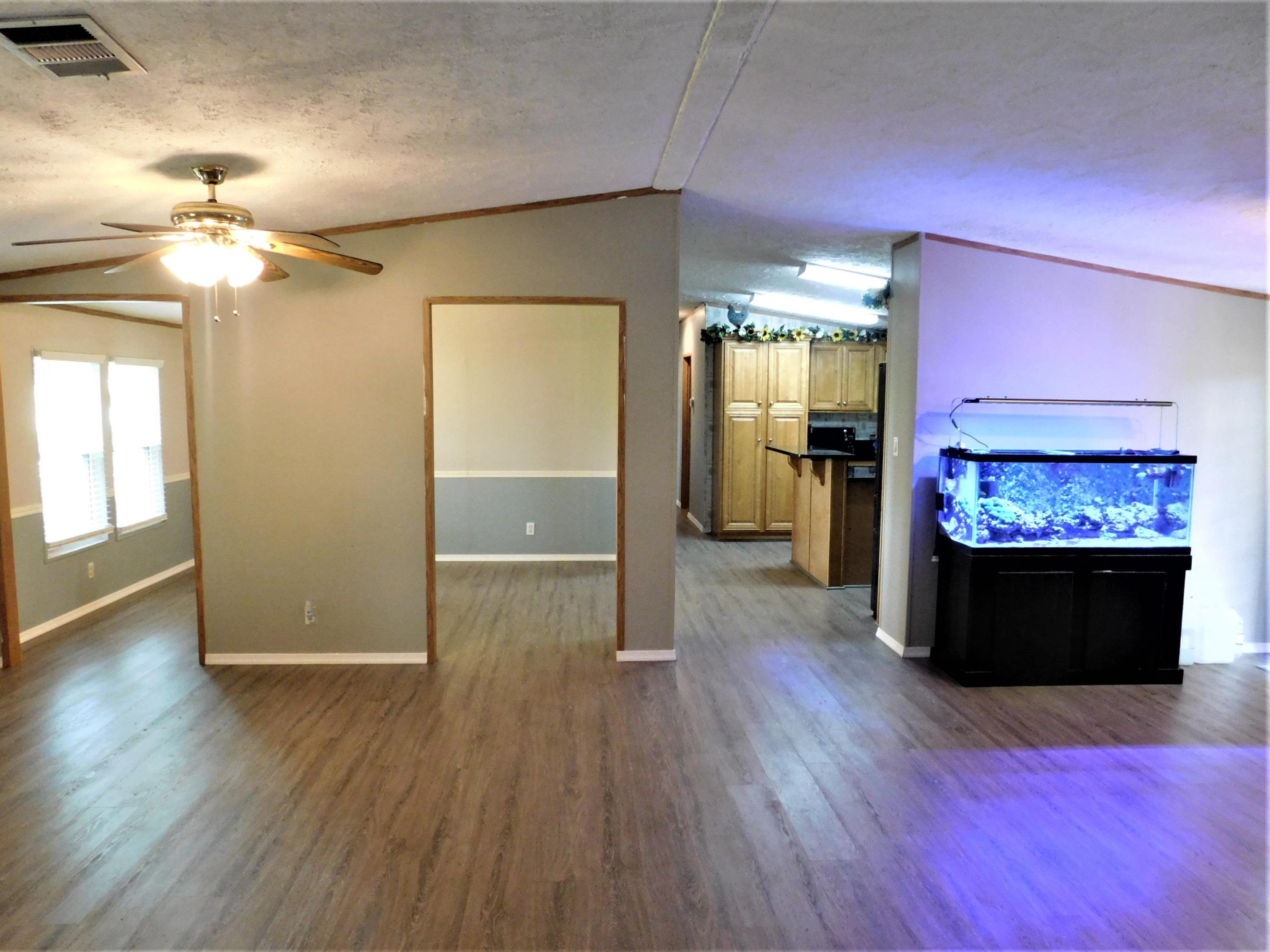 1533 Messick Road Baker, FL 32531 - Photo 19 of 40 a view of a living room with hardwood floor and a ceiling fan