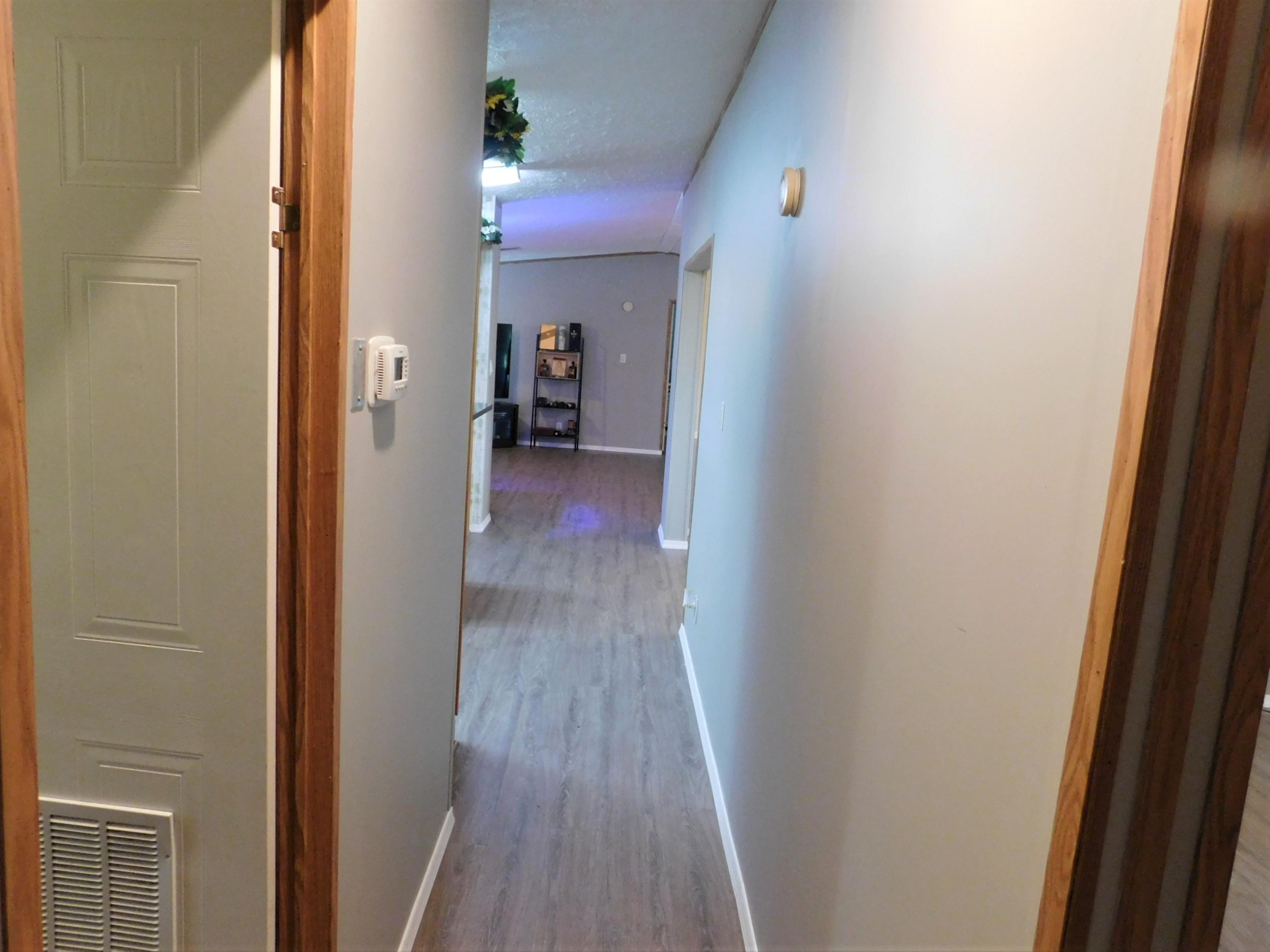 1533 Messick Road Baker, FL 32531 - Photo 24 of 40 a view of a hallway with wooden floor
