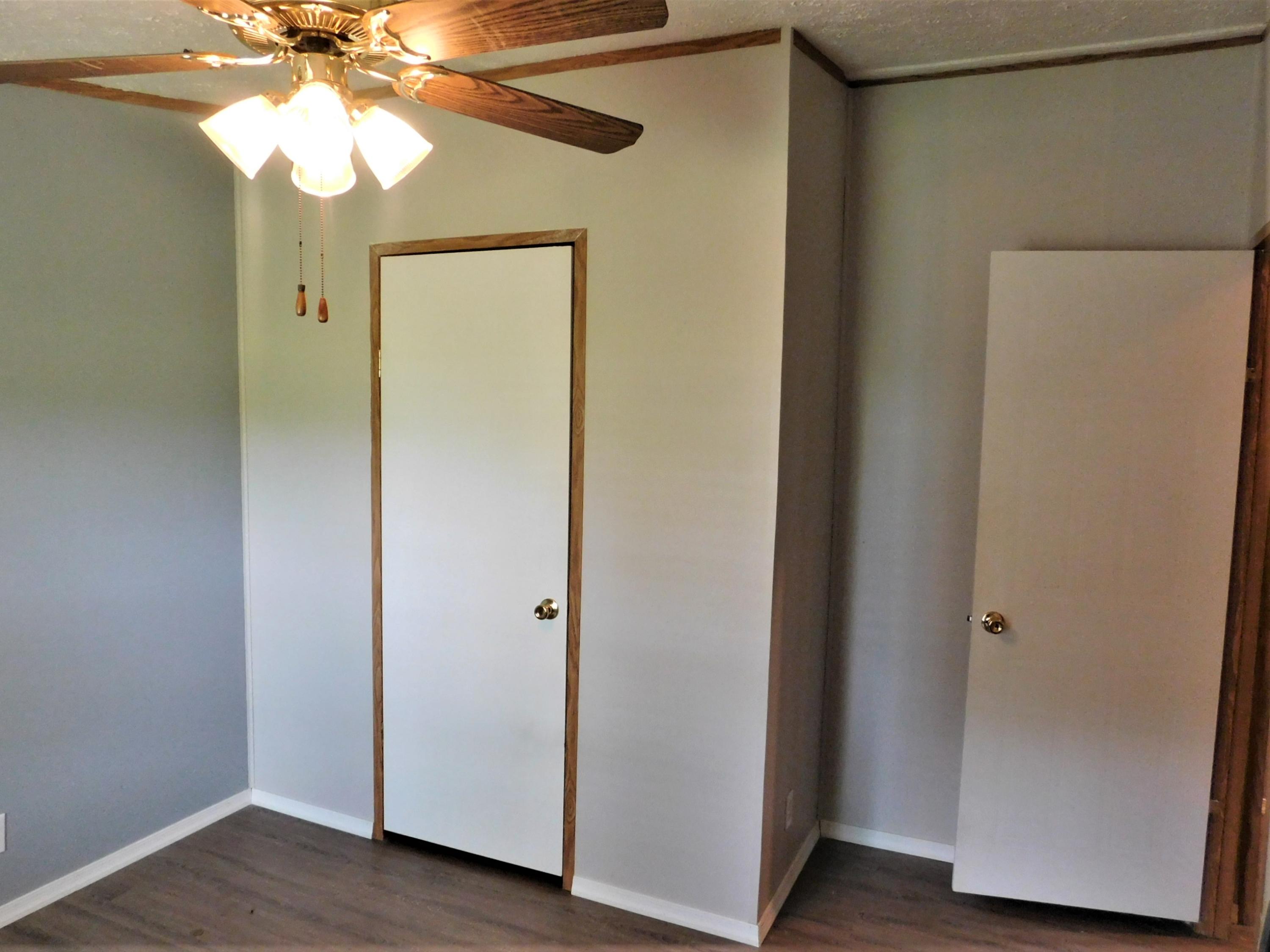1533 Messick Road Baker, FL 32531 - Photo 26 of 40 a view of a hallway to a bedroom with wooden floor