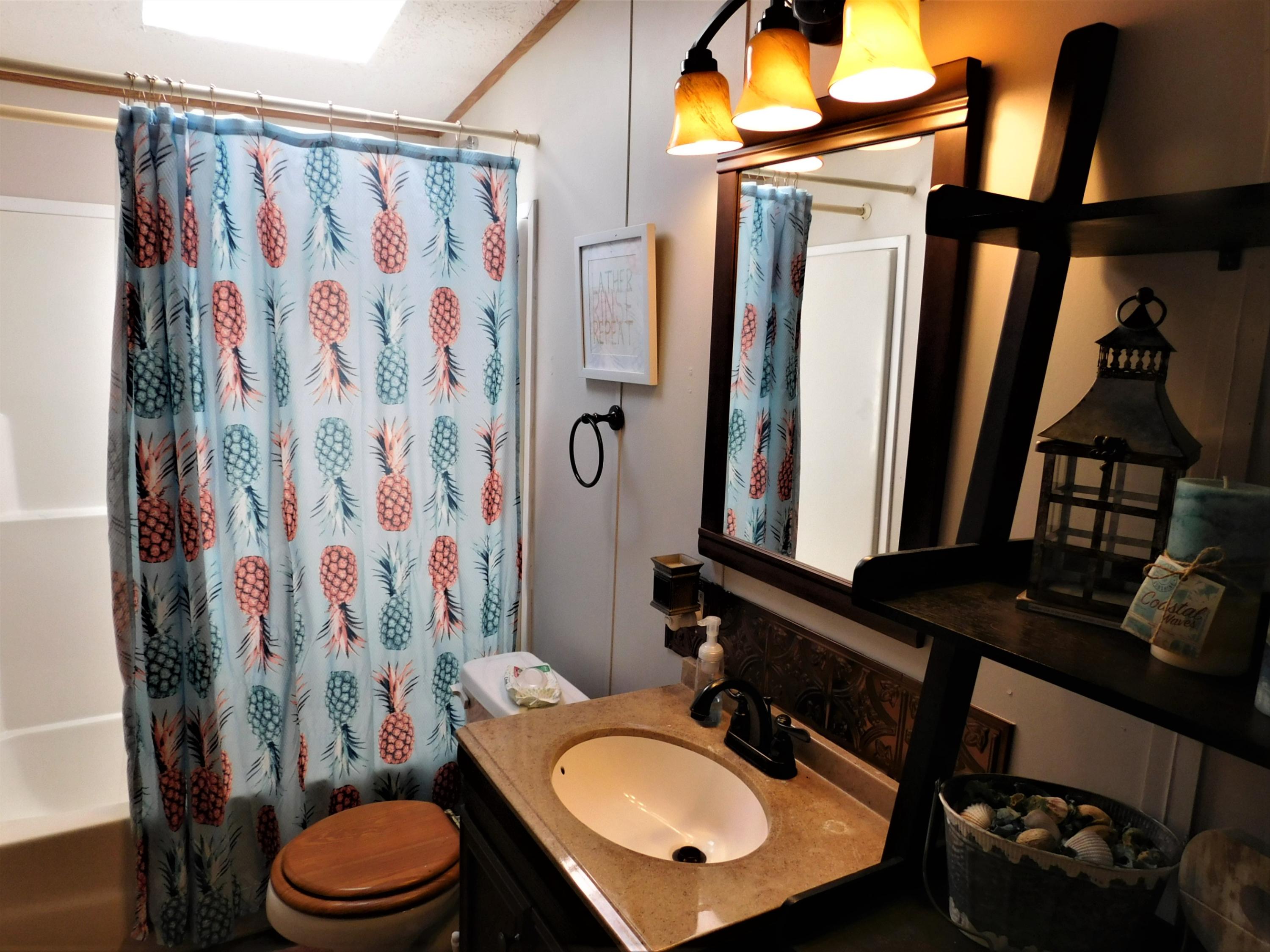 1533 Messick Road Baker, FL 32531 - Photo 28 of 40 a bathroom with a sink toilet and shower