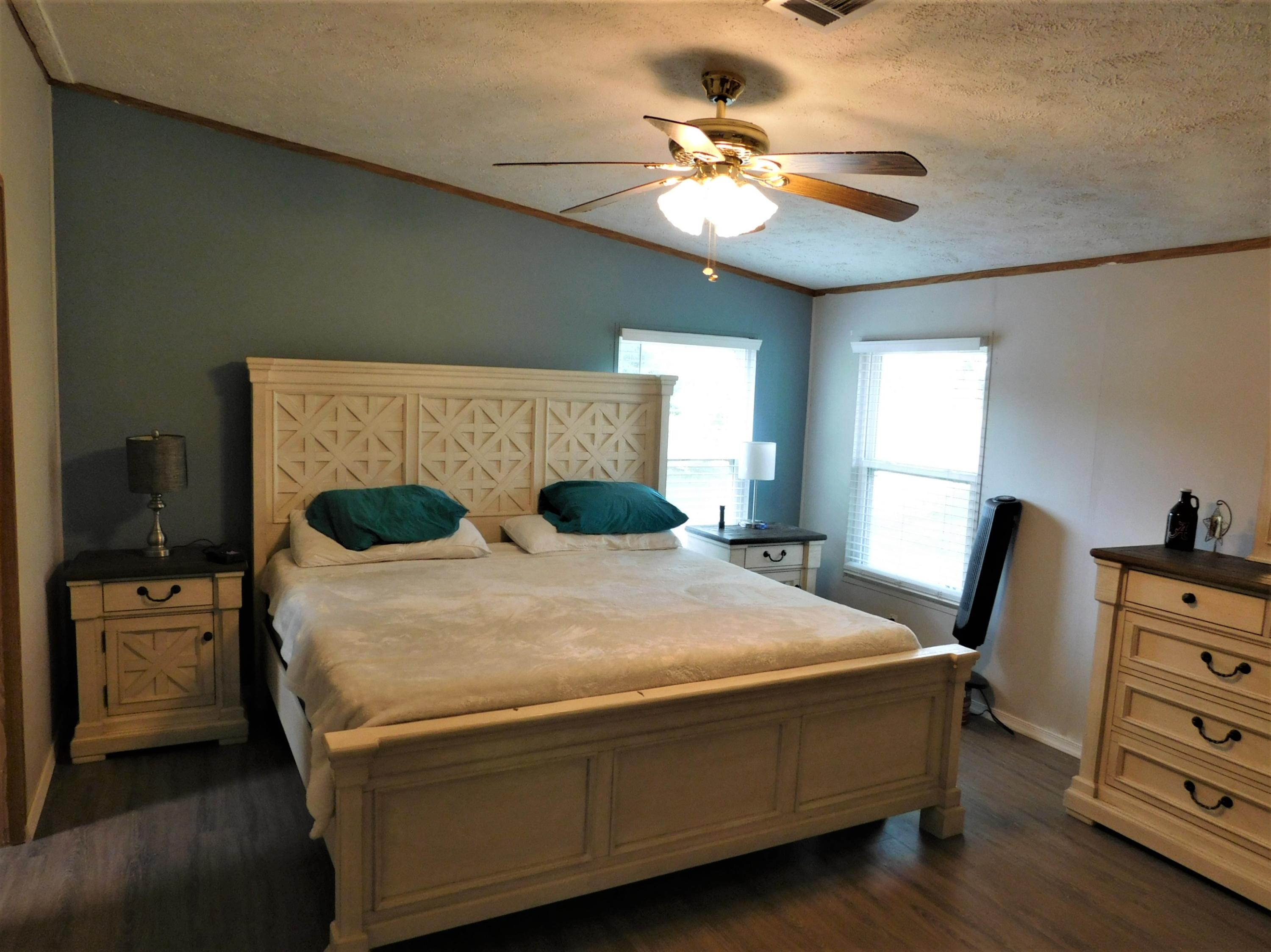 1533 Messick Road Baker, FL 32531 - Photo 29 of 40 a bedroom with a bed and wooden floor