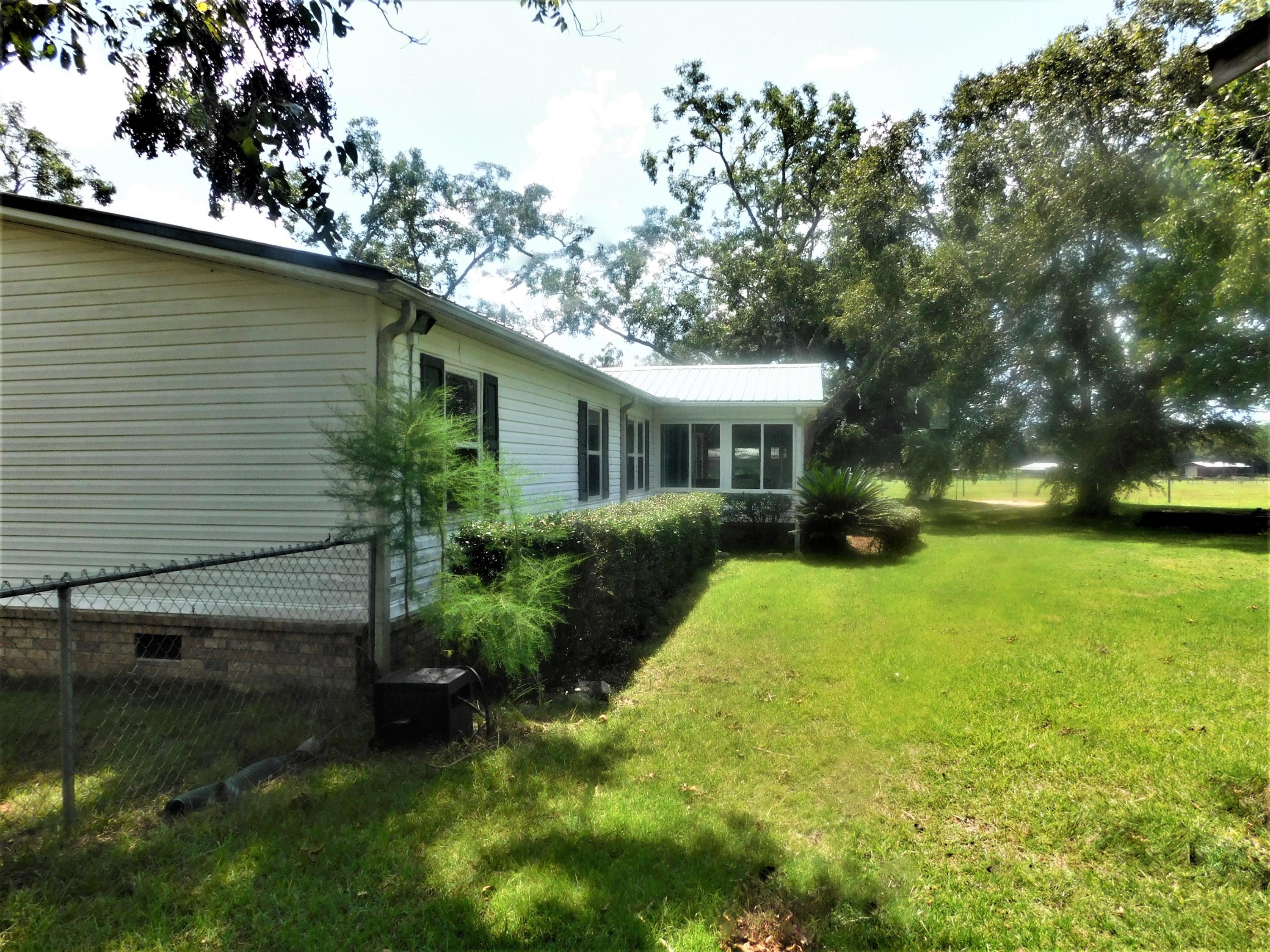 1533 Messick Road Baker, FL 32531 - Photo 4 of 40 a view of house with backyard and trees