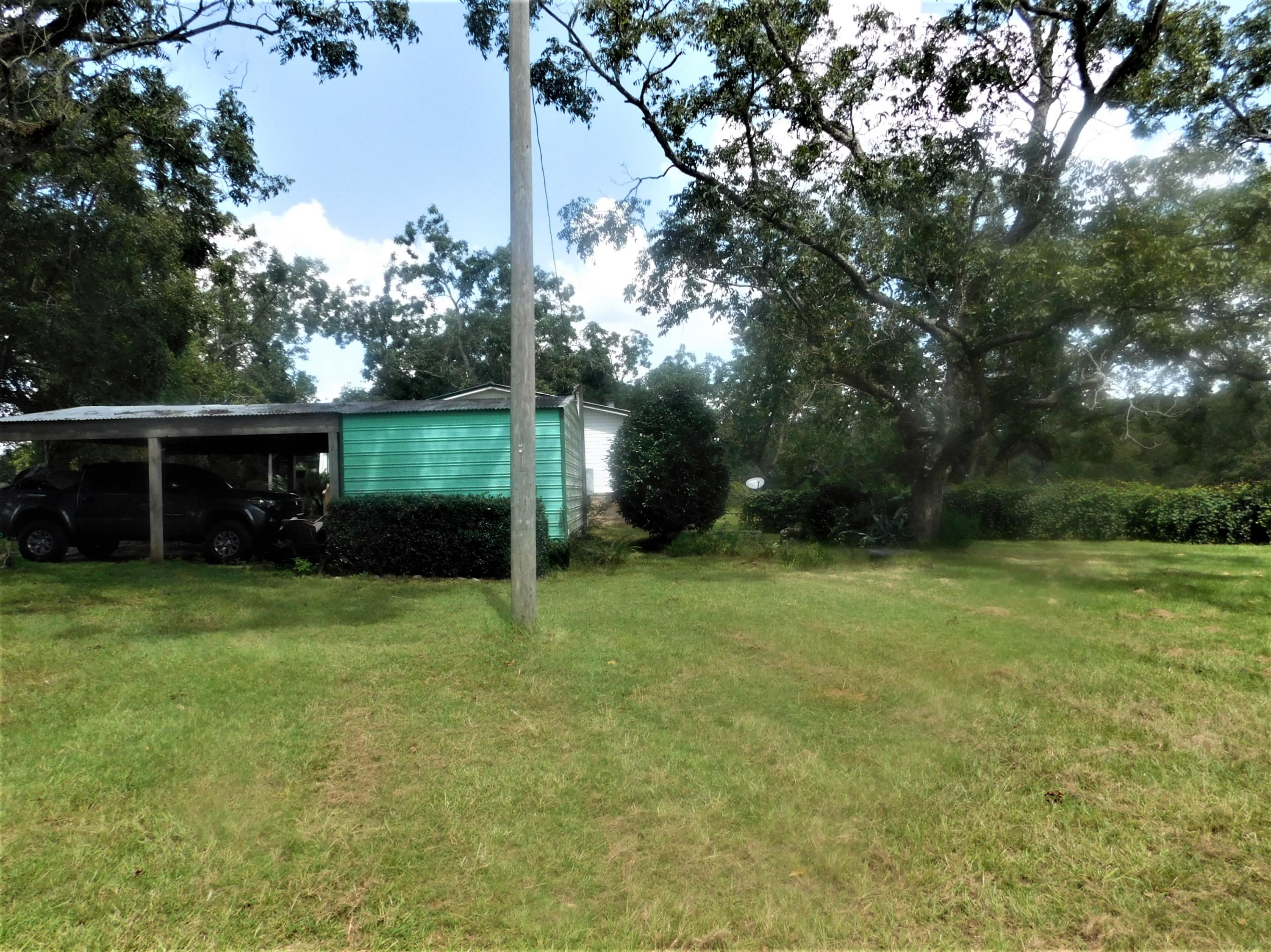 1533 Messick Road Baker, FL 32531 - Photo 36 of 40 a view of a backyard with a garden and entertaining space