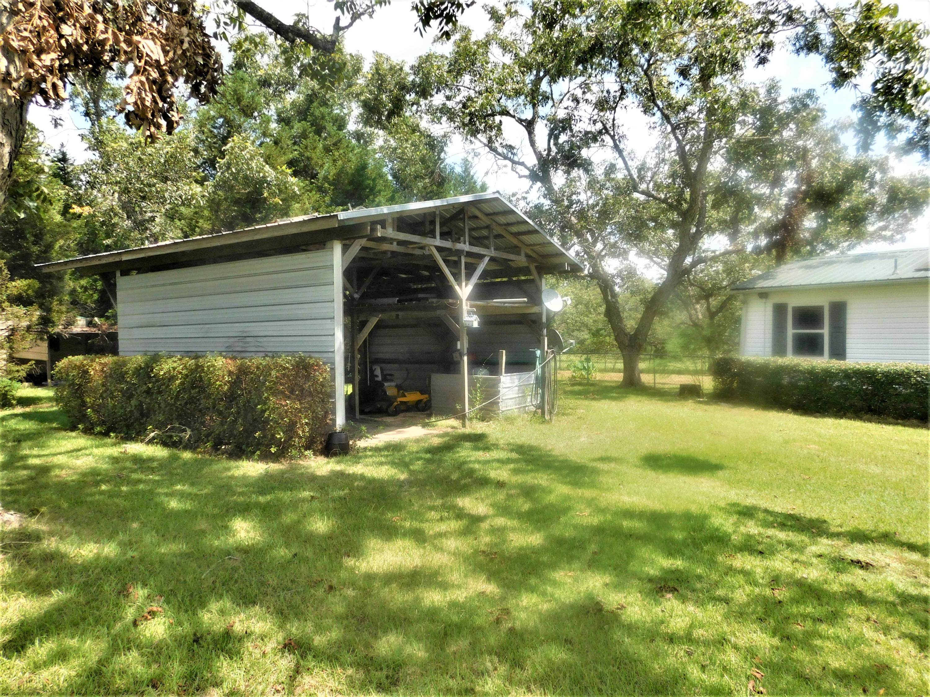 1533 Messick Road Baker, FL 32531 - Photo 5 of 40 a view of a house with backyard and garden