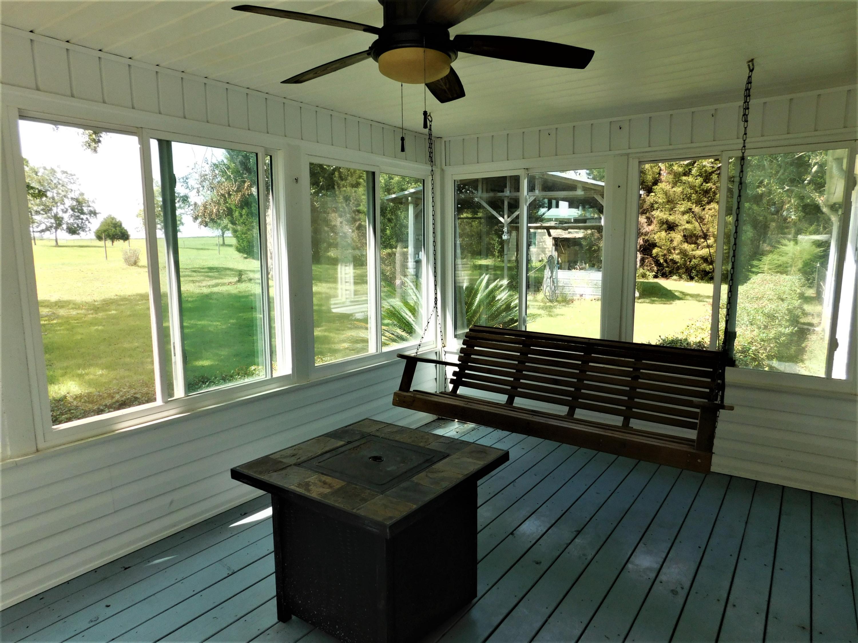 1533 Messick Road Baker, FL 32531 - Photo 8 of 40 a room with lots of windows and outdoor seating