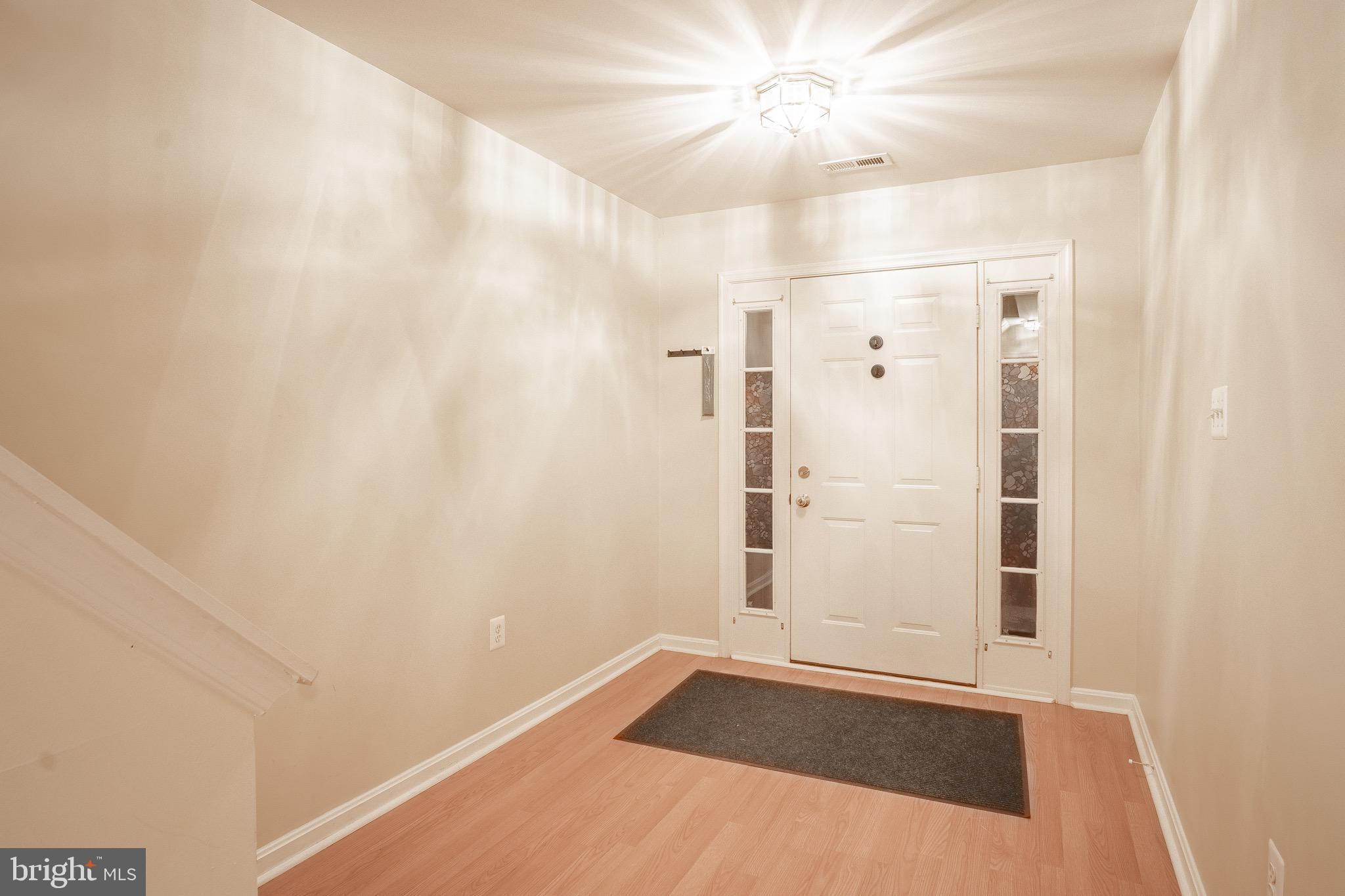 104 Penwick Circle Frederick, MD 21702 - Photo 4 of 24 an empty room with wooden floor and fan