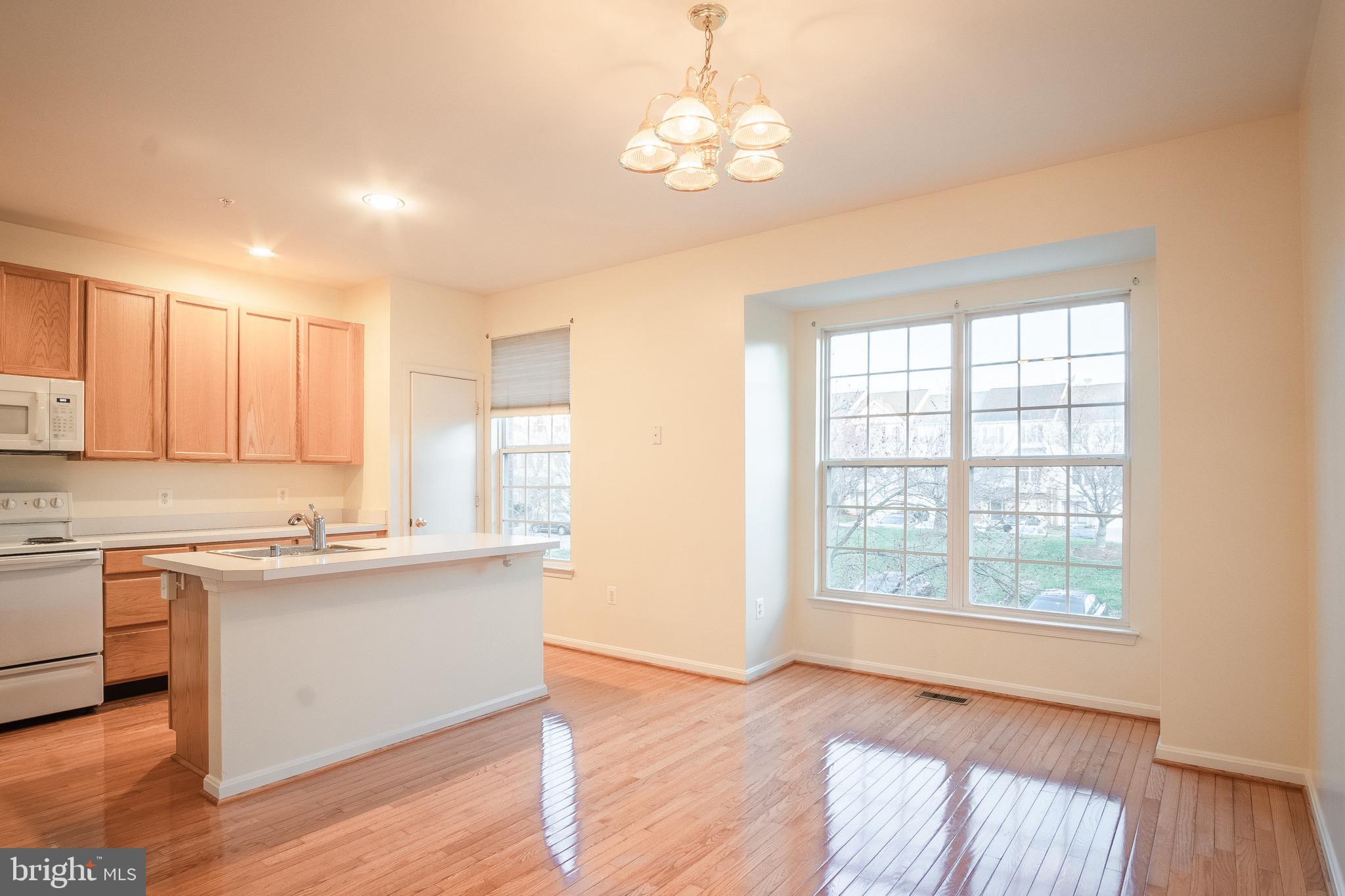 104 Penwick Circle Frederick, MD 21702 - Photo 6 of 24 a kitchen with stainless steel appliances granite countertop a sink cabinets and wooden floor