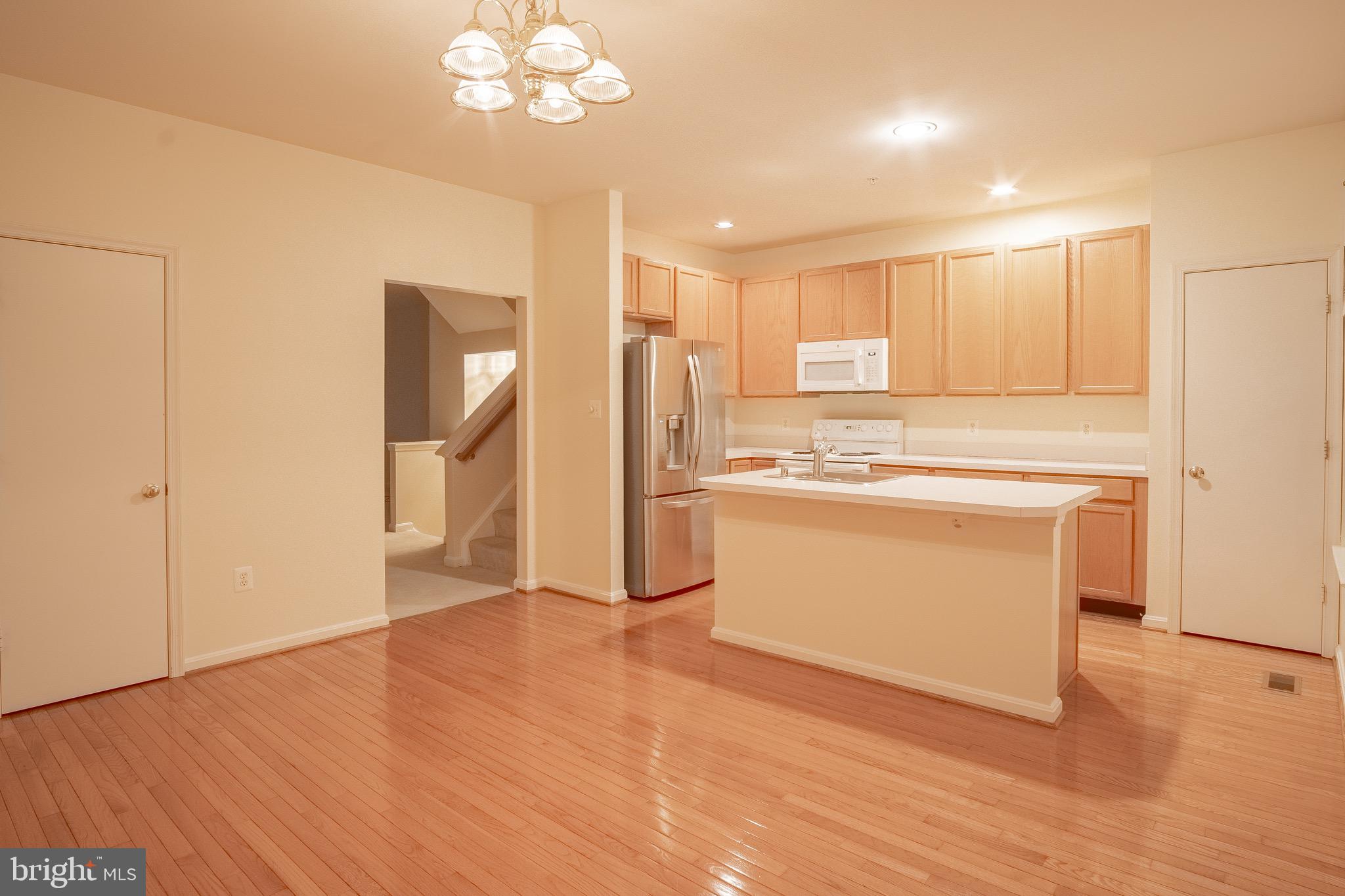 104 Penwick Circle Frederick, MD 21702 - Photo 7 of 24 a view of a kitchen with a sink a refrigerator and window