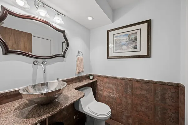 a bathroom with a toilet and a mirror