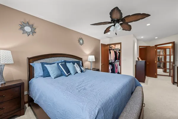 a bed room with a bed and a chandelier