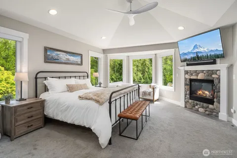 a bedroom with a bed and a fireplace