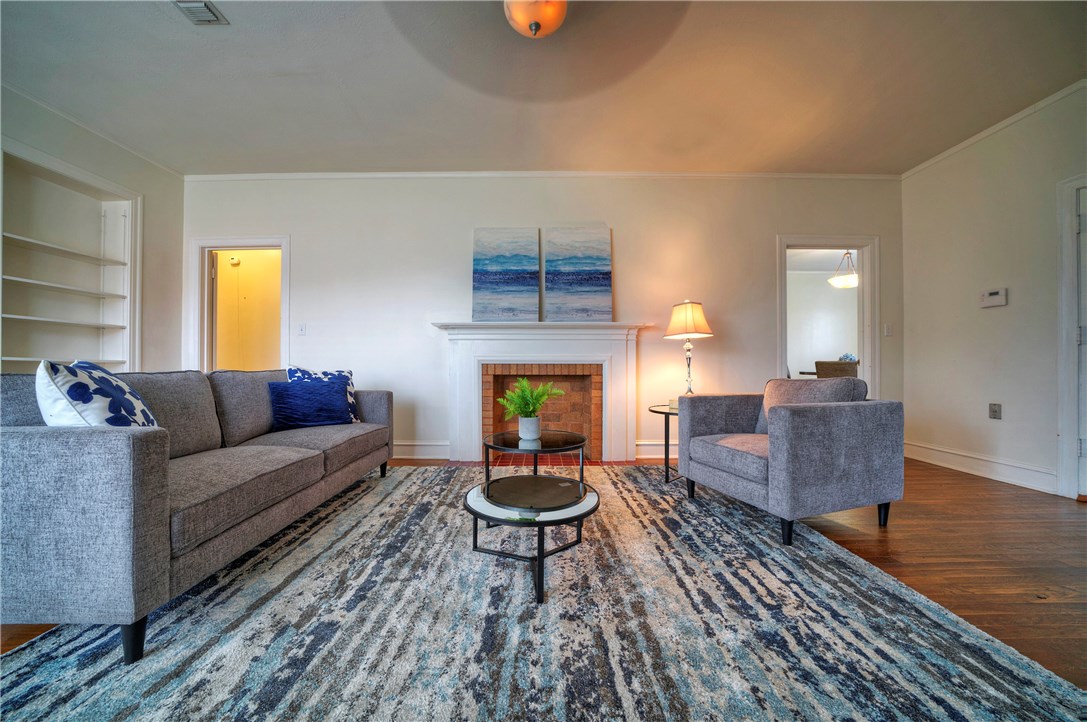 a living room with furniture a window and a fireplace