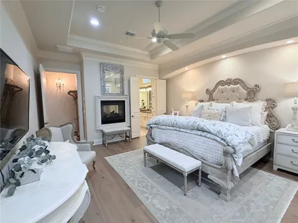 a spacious bedroom with a bed a couch and dresser