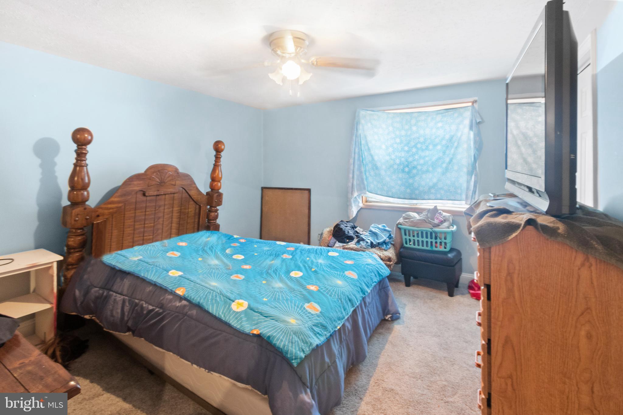 752 Bennington Road Folcroft, PA 19032 - Photo 5 of 11 a bedroom with a bed and a chandelier