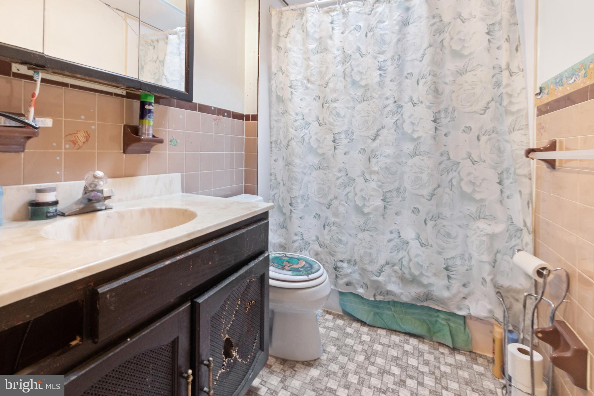 752 Bennington Road Folcroft, PA 19032 - Photo 6 of 11 a bathroom with a granite countertop sink a toilet and a mirror