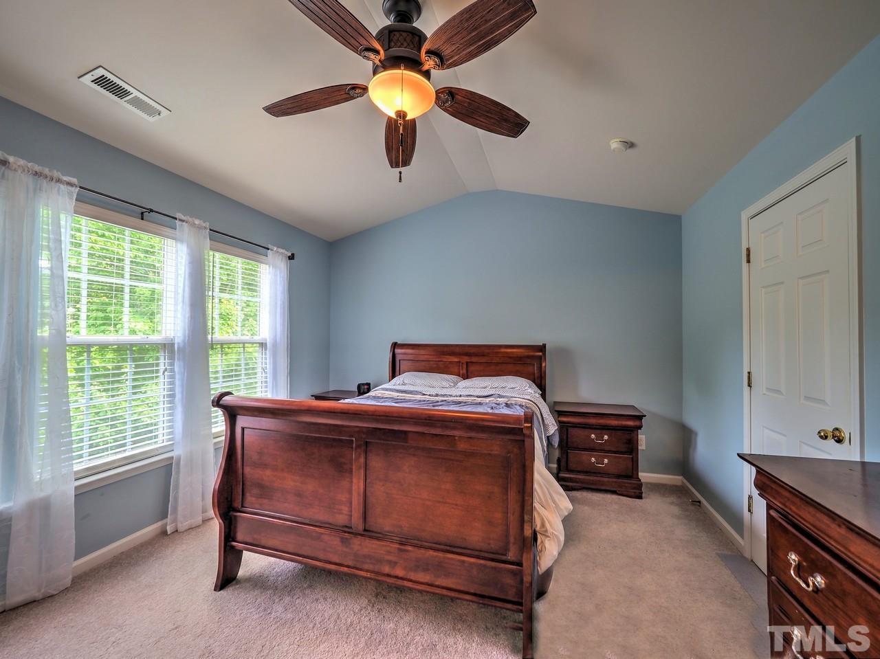 7250 Galon Glen Road Raleigh, NC 27613 - Photo 14 of 27 a bedroom with a bed and a ceiling fan