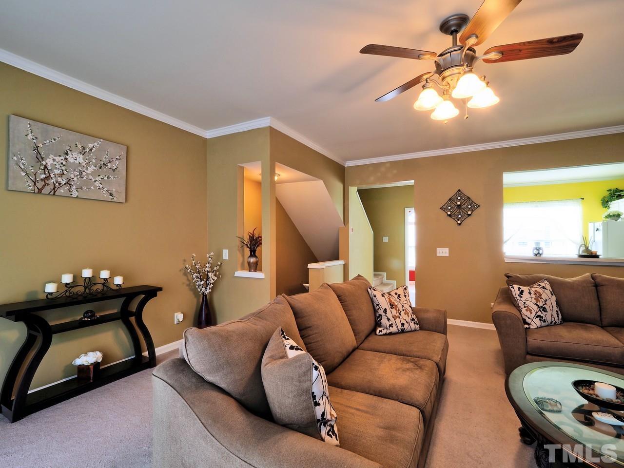 7250 Galon Glen Road Raleigh, NC 27613 - Photo 8 of 27 a living room with furniture and a chandelier