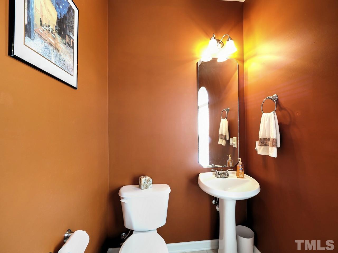 7250 Galon Glen Road Raleigh, NC 27613 - Photo 10 of 27 a bathroom with a toilet sink and mirror