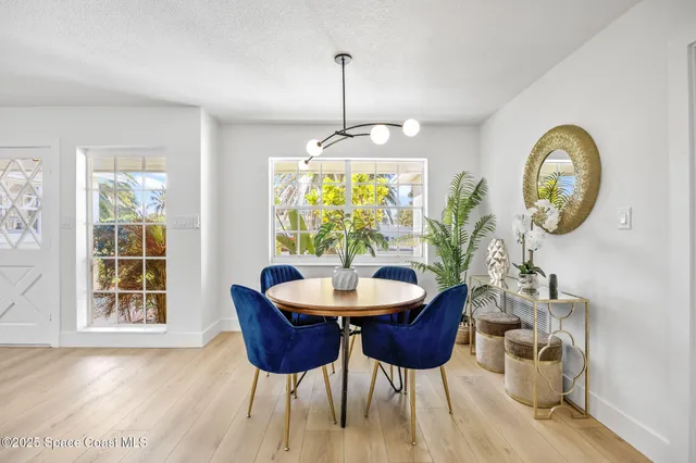 a dining room with furniture a window and a chandelier