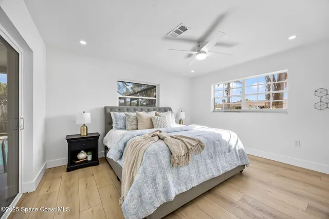 a large bedroom with bed and window