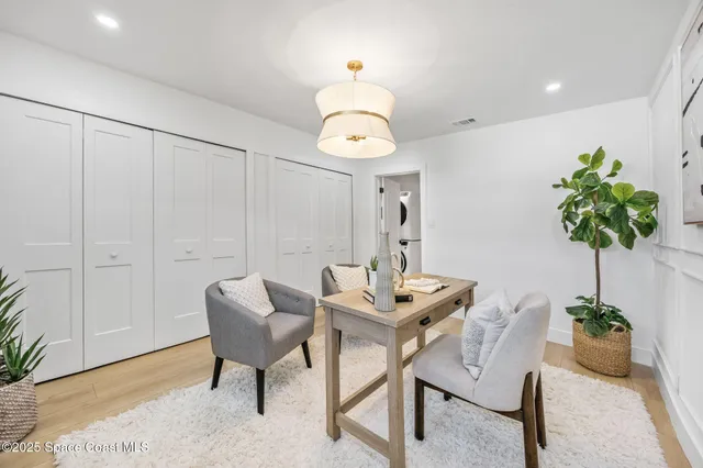 a view of a livingroom with furniture and a potted plant
