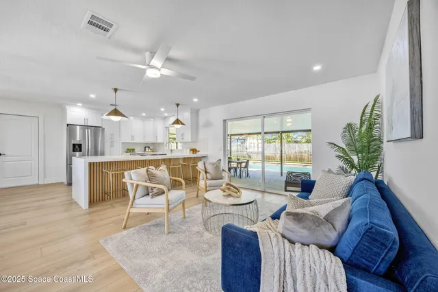 a living room with furniture and kitchen view