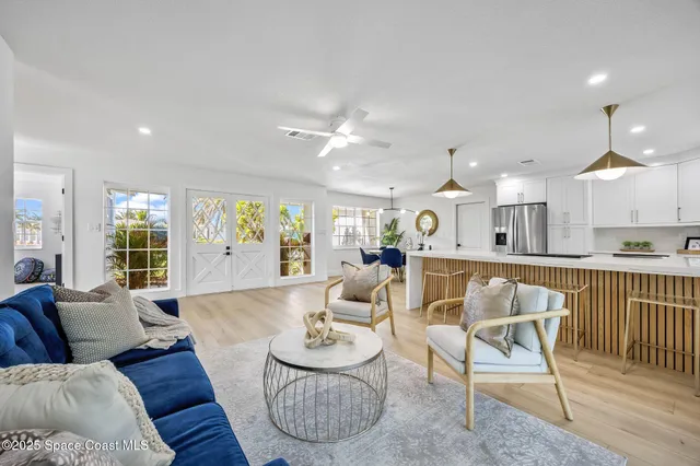 a living room with furniture and kitchen view