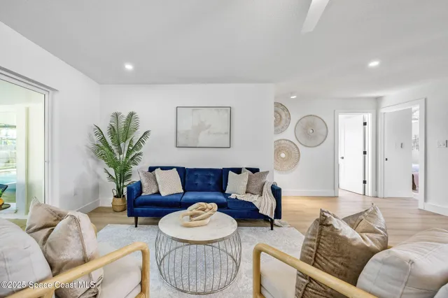 a living room with furniture potted plant and a window